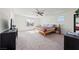 Spacious bedroom with ceiling fan, plush carpet flooring, and natural light from several windows at 3981 E Teller Dr, Pahrump, NV 89061