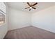 Cozy bedroom featuring neutral carpet, white walls, and ceiling fan at 3981 E Teller Dr, Pahrump, NV 89061