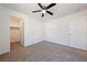 Bedroom with ceiling fan, plush carpet flooring, and walk-in closet at 3981 E Teller Dr, Pahrump, NV 89061