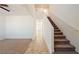 Bright hallway featuring stairs with neutral carpet and tile flooring at 3981 E Teller Dr, Pahrump, NV 89061