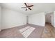 Bright living room with neutral carpet, white walls, and ceiling fan at 3981 E Teller Dr, Pahrump, NV 89061