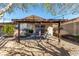 Cozy back patio features a pergola, string lights and neutral landscaping providing an entertainment space at 432 Bottle Brush Way, Henderson, NV 89015