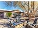 Backyard includes a stone fire pit, Adirondack chairs, mature trees, and neutral landscaping at 432 Bottle Brush Way, Henderson, NV 89015