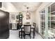 Dining room features a dining table with seating for four, sliding glass doors, and natural light at 432 Bottle Brush Way, Henderson, NV 89015
