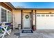 Inviting front entrance with a decorated door, a two-car garage, and appealing landscaping adding to its curb appeal at 432 Bottle Brush Way, Henderson, NV 89015