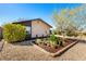 Charming home with desert landscaping, and a quaint windmill decoration at 432 Bottle Brush Way, Henderson, NV 89015
