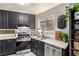Updated kitchen with granite countertops, stainless appliances, and new window at 432 Bottle Brush Way, Henderson, NV 89015