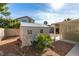 Exterior shed in a gravel backyard featuring desert landscaping and a covered patio at 455 Paulson Dr, Las Vegas, NV 89123