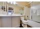 Bathroom featuring shower-tub combo and vanity with grey cabinetry at 455 Paulson Dr, Las Vegas, NV 89123