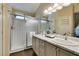 Modern bathroom featuring a double sink vanity with elegant counters and a glass shower with white subway tile at 455 Paulson Dr, Las Vegas, NV 89123