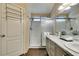 This bathroom features a double sink vanity with elegant counters and a glass shower with white subway tile at 455 Paulson Dr, Las Vegas, NV 89123