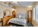 Well lit bedroom featuring a comfortable bed, dark wood floors, and a built-in shelf with storage at 455 Paulson Dr, Las Vegas, NV 89123
