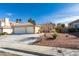 Charming single-story home featuring a two-car garage, tile roof, and desert landscaping at 455 Paulson Dr, Las Vegas, NV 89123