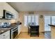Cozy eat-in kitchen area with stainless steel appliances and sliding glass door to the backyard at 455 Paulson Dr, Las Vegas, NV 89123