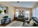 Cozy living room with wood floors, plantation shutters, neutral walls, and comfortable seating at 455 Paulson Dr, Las Vegas, NV 89123