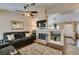 Open-concept living room with a fireplace, TV, and a view into the kitchen, great for gatherings at 455 Paulson Dr, Las Vegas, NV 89123