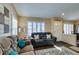 Cozy living room featuring plantation shutters, comfortable seating, and neutral decor at 455 Paulson Dr, Las Vegas, NV 89123