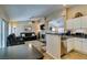 Open-concept living room and kitchen featuring a cozy fireplace and eat-in kitchen at 455 Paulson Dr, Las Vegas, NV 89123