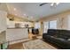 Well-lit living room featuring a kitchen view and direct access to the backyard via sliding glass doors at 455 Paulson Dr, Las Vegas, NV 89123