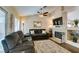 Spacious living room with comfortable seating, a fireplace, and a ceiling fan for added comfort at 455 Paulson Dr, Las Vegas, NV 89123