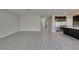 Open-concept living area featuring modern gray wood-look tile flooring and neutral paint at 456 Lost Horizon Ave, Henderson, NV 89002