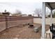 Spacious backyard with stone pavers, stone benches, a fire pit, and a block wall fence for privacy at 4850 Straight Flush Dr # 103, Las Vegas, NV 89122