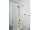 Cozy bathroom featuring a shower/tub with white tile surround and a blue patterned shower curtain at 4850 Straight Flush Dr # 103, Las Vegas, NV 89122