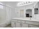 The bathroom features a tub-shower, vanity, and large mirror at 4850 Straight Flush Dr # 103, Las Vegas, NV 89122