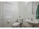 A well-lit powder room with a sink, toilet, and vanity at 4850 Straight Flush Dr # 103, Las Vegas, NV 89122