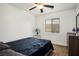 This bedroom features a comfy bed, a ceiling fan, and a window bringing in natural light at 4850 Straight Flush Dr # 103, Las Vegas, NV 89122