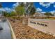 Nevada Ranch community entrance sign with lush landscaping and well-maintained surroundings on a partly cloudy day at 4850 Straight Flush Dr # 103, Las Vegas, NV 89122