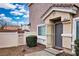 Inviting front entrance featuring a screened door, complemented by a white fence and manicured landscaping at 4850 Straight Flush Dr # 103, Las Vegas, NV 89122