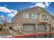 Charming two-story townhome featuring double garages, neutral stucco, stone accents, and a welcoming exterior at 4850 Straight Flush Dr # 103, Las Vegas, NV 89122