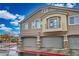 Charming three-story home with neutral paint, stone accents, and a small balcony above the garage at 4850 Straight Flush Dr # 103, Las Vegas, NV 89122