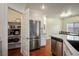 Charming kitchen features white cabinetry and a pantry for extra storage at 4850 Straight Flush Dr # 103, Las Vegas, NV 89122