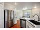 This kitchen offers stainless steel appliances, granite countertops, and modern fixtures at 4850 Straight Flush Dr # 103, Las Vegas, NV 89122