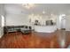 Spacious open-concept living area featuring hardwood floors seamlessly flowing into the adjacent kitchen space at 4850 Straight Flush Dr # 103, Las Vegas, NV 89122