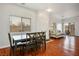 Open-concept living room and dining area with hardwood floors and modern furnishings under natural lighting at 4850 Straight Flush Dr # 103, Las Vegas, NV 89122