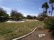 Enjoy the outdoors in this community park featuring lush green grass, seating, and play area at 4850 Straight Flush Dr # 103, Las Vegas, NV 89122