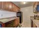 Compact kitchen featuring wood cabinets and a black appliances at 5161 Lindell Rd # 201, Las Vegas, NV 89118