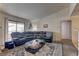 Relaxing living room with a large sectional, glass coffee table, and sliding glass door to the balcony at 5161 Lindell Rd # 201, Las Vegas, NV 89118