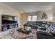Cozy living room features a comfortable sectional, sleek glass coffee table, and modern entertainment center at 5161 Lindell Rd # 201, Las Vegas, NV 89118