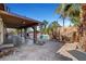 Large covered patio with outdoor seating area, overlooking a custom pool with rock waterfall feature at 563 Moon Chase St, Las Vegas, NV 89110