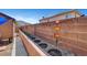Landscaped backyard featuring a retaining wall flower bed, decorative lighting and views of the mountains beyond the neighborhood at 563 Moon Chase St, Las Vegas, NV 89110
