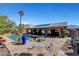 Expansive backyard featuring a custom pool with waterfall, patio, and lush tropical landscaping at 563 Moon Chase St, Las Vegas, NV 89110