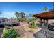 Large backyard featuring pool area, deck with sitting area and lush tropical landscaping at 563 Moon Chase St, Las Vegas, NV 89110