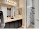 Bright bathroom features double sinks, a large mirror and a beautifully tiled walk-in shower at 563 Moon Chase St, Las Vegas, NV 89110