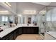 Bright bathroom features a double sink vanity, a tiled floor, and a glass enclosed shower at 563 Moon Chase St, Las Vegas, NV 89110