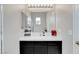 Bright bathroom featuring a single sink vanity with a mirror and modern lighting at 563 Moon Chase St, Las Vegas, NV 89110