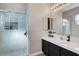 Neutral bathroom vanity and tiled shower with glass doors at 563 Moon Chase St, Las Vegas, NV 89110